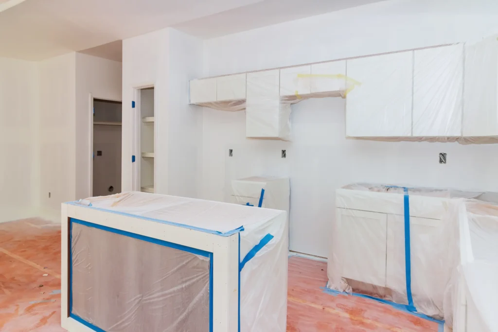 Kitchen cabinets and counters covered for painting prep in Chico, CA