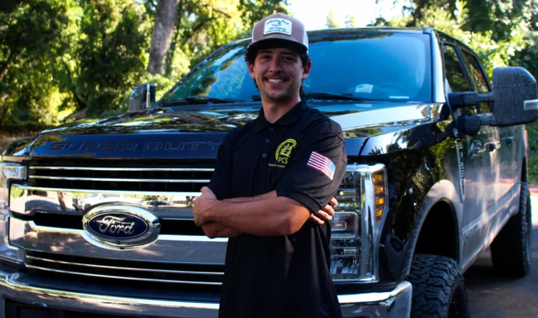 Conner Hart of TC Painting Chico standing in front of company truck