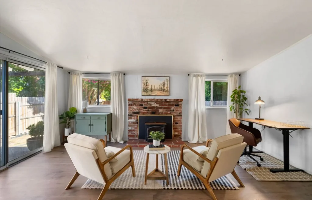 Freshly painted living room with brick fireplace in Chico Airbnb