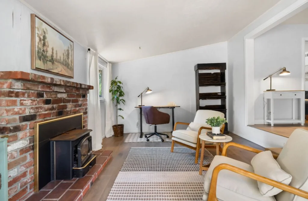 Freshly painted living room with brick fireplace in Chico Airbnb