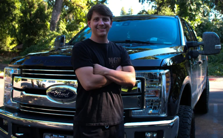 Tanner Hart, owner of TC Painting in Chico, CA standing in front of company truck